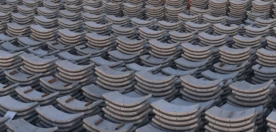 Hundreds of curved concrete segments tacked in pile. It resembles a carpark