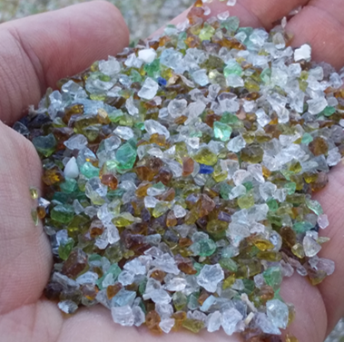 Glass crushed into a sand like grain.