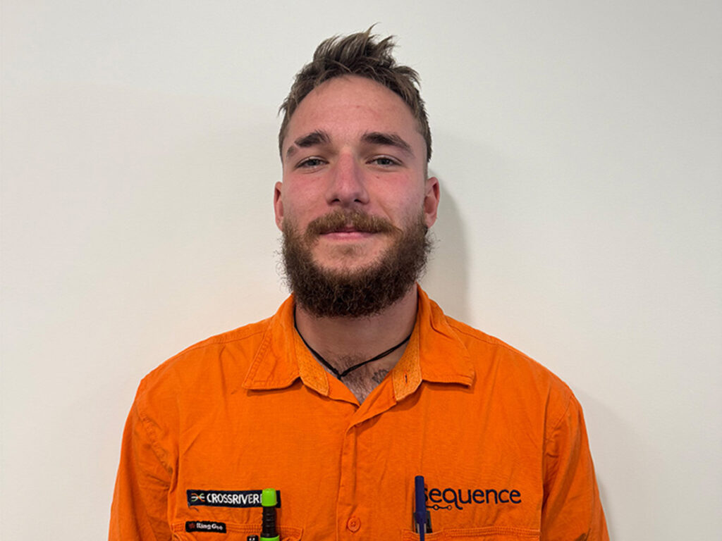 Picture of Nelson Gaston in their orange Sequence work shirt.