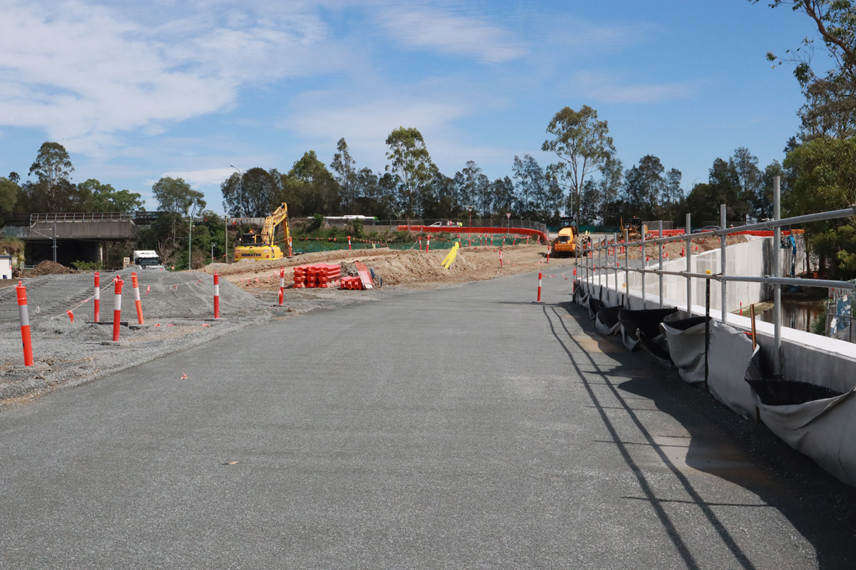 Station access road construction is underway, with retaining walls underpinning the road
