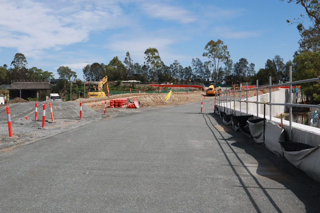 station access road construction is underway, with retaining walls underpinning the road